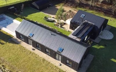 Contemporary Cotswolds family house by Greenaway Architecture with modern black timber exterior and landscaped garden