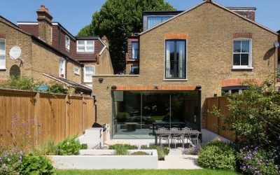 Modern rear house extension with glass doors and landscaped garden in London residential property