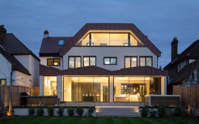 Contemporary luxury home with glass façade and warm interior lighting, modern residential architecture featured in Architecture Vogue magazine