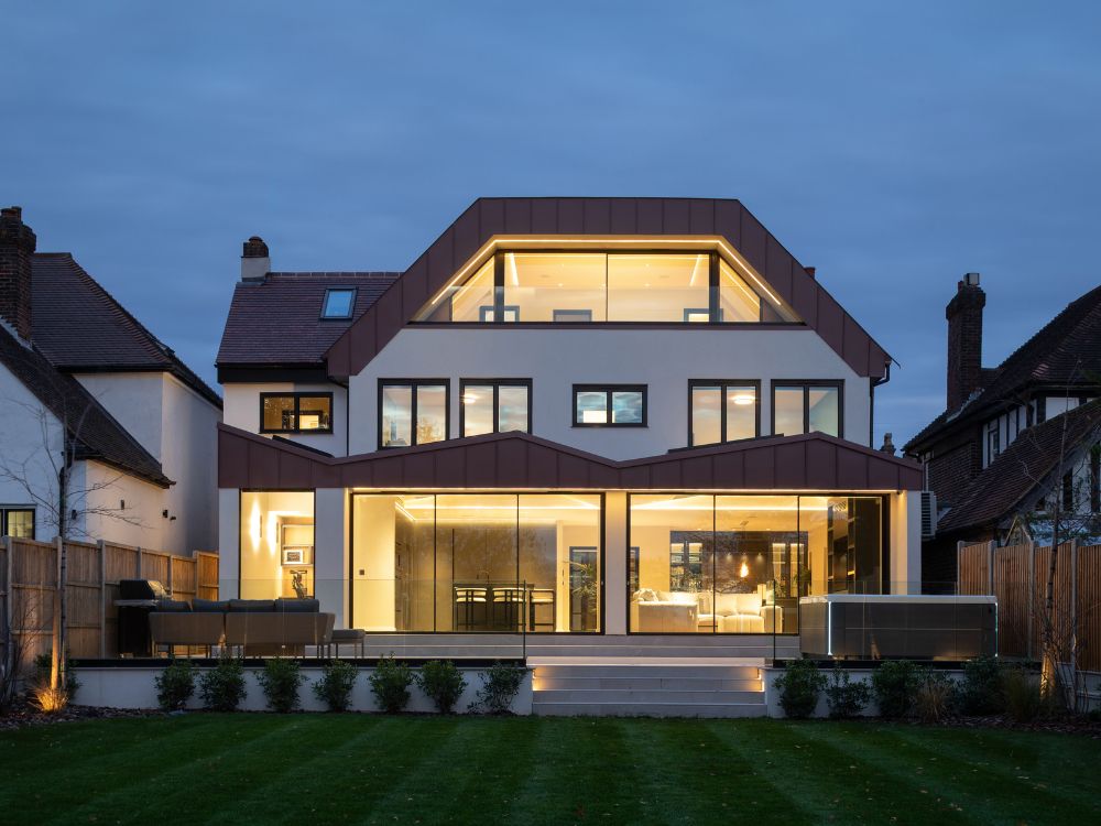 1 Contemporary luxury home with glass façade and warm interior lighting, modern residential architecture featured in Architecture Vogue magazine