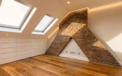 Contemporary loft interior with exposed brick chimney feature, skylights and oak flooring, featured in Architecture Magazine — showcasing modern renovation design and natural light integration