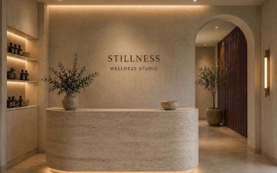 Minimalist wellness studio interior with curved stone reception desk, soft lighting and natural materials, featured in Architecture Magazine — showcasing serene spatial design and contemporary craftsmanship