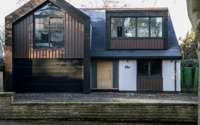 Contemporary two‑storey home with dark cladding and slate roof, featured in Architecture Magazine — showcasing modern residential design and sustainable materials in suburban London
