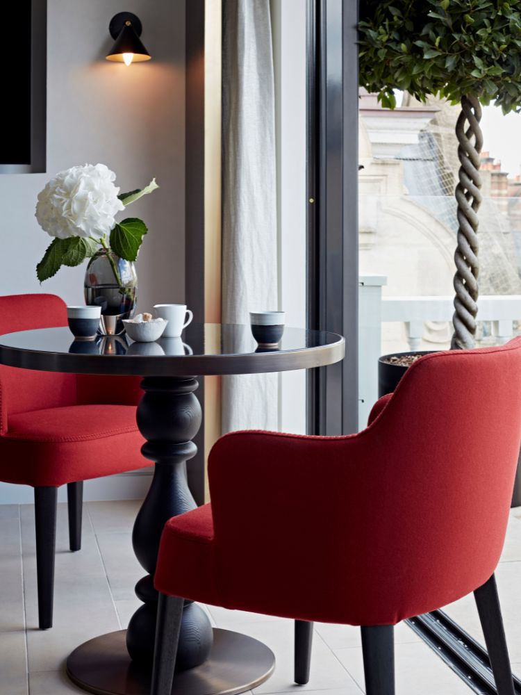 coffee table and 2 red chairs image by the built environment network
